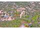 Aerial view of property showing house, detached garage, and surrounding land at 12404 Dolquieb Ln, Weeki Wachee, FL 34614