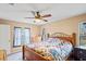 Comfortable bedroom with ceiling fan and wood bed frame at 12404 Dolquieb Ln, Weeki Wachee, FL 34614