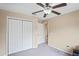 Bright bedroom featuring double door closet and ceiling fan at 12404 Dolquieb Ln, Weeki Wachee, FL 34614