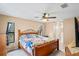 Spacious bedroom with ceiling fan and large window at 12404 Dolquieb Ln, Weeki Wachee, FL 34614