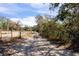 Long driveway with wooden fence at 12404 Dolquieb Ln, Weeki Wachee, FL 34614