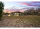 House exterior at sunset, large yard at 12404 Dolquieb Ln, Weeki Wachee, FL 34614