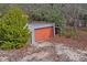 Detached garage with orange door at 12404 Dolquieb Ln, Weeki Wachee, FL 34614