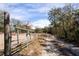 Metal gate leading to property at 12404 Dolquieb Ln, Weeki Wachee, FL 34614