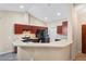 Modern kitchen with dark wood cabinets and breakfast bar at 12404 Dolquieb Ln, Weeki Wachee, FL 34614