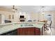 Open kitchen with breakfast bar and view into living room at 12404 Dolquieb Ln, Weeki Wachee, FL 34614