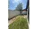 Small backyard with artificial turf and a privacy fence at 2066 Sunset Point Rd # 97, Clearwater, FL 33765