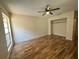 Bright bedroom with hardwood floors and ceiling fan at 2066 Sunset Point Rd # 97, Clearwater, FL 33765