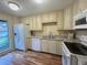 Well-equipped kitchen with granite counters and wood flooring at 2066 Sunset Point Rd # 97, Clearwater, FL 33765