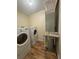 Laundry room with washer, dryer, and water heater at 2066 Sunset Point Rd # 97, Clearwater, FL 33765