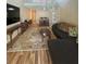 Spacious living room, featuring hardwood floors and a spiral staircase at 2066 Sunset Point Rd # 97, Clearwater, FL 33765