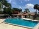 Community swimming pool with lounge chairs at 2066 Sunset Point Rd # 97, Clearwater, FL 33765