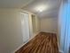 Storage room with wood floors and a bi-fold closet door at 2066 Sunset Point Rd # 97, Clearwater, FL 33765