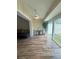 Sunroom with wood floors, ceiling fan, and sliding glass doors at 2066 Sunset Point Rd # 97, Clearwater, FL 33765