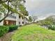 Community view, lush landscaping, pond at 2119 Elm St # 101, Dunedin, FL 34698