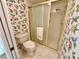 Bathroom featuring a shower, toilet, and floral wallpaper at 2119 Elm St # 101, Dunedin, FL 34698