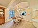 Combined living and dining area with large windows and chandelier at 2119 Elm St # 101, Dunedin, FL 34698