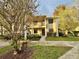 Two-story condo building with walkway and landscaping at 2119 Elm St # 101, Dunedin, FL 34698