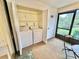 Convenient indoor laundry room with washer and dryer, located near the screened porch at 2119 Elm St # 101, Dunedin, FL 34698