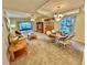 Spacious living area with dining set and sliding doors to patio at 2119 Elm St # 101, Dunedin, FL 34698
