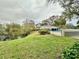 Community pool with pond and lush trees at 2119 Elm St # 101, Dunedin, FL 34698