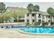 Inviting community pool with lounge chairs at 2119 Elm St # 101, Dunedin, FL 34698