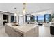 Modern kitchen island with marble top, open to living room with water view at 301 1St S St # 1002, St Petersburg, FL 33701