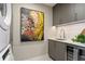 Modern laundry room with stacked washer and dryer, a utility sink, and stylish cabinetry at 301 1St S St # 1002, St Petersburg, FL 33701