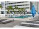 Relaxing rooftop pool with lounge chairs and umbrellas at 301 1St S St # 1002, St Petersburg, FL 33701