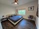 Spacious bedroom with a king-size bed and wood flooring at 324 W Giddens Ave, Tampa, FL 33603