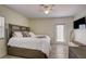 Main bedroom with king bed, private door to balcony, and TV at 4516 Seagull Dr # 419, New Port Richey, FL 34652