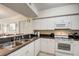 White kitchen with granite countertops and stainless steel appliances at 4516 Seagull Dr # 419, New Port Richey, FL 34652