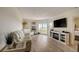 Bright living room with white sofas, fireplace, and hardwood floors at 4516 Seagull Dr # 419, New Port Richey, FL 34652