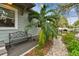 Inviting front porch with a decorative bench and lush landscaping at 487 9Th N Ave, St Petersburg, FL 33701