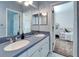 Double vanity bathroom with a view into a bedroom at 5614 Seagrass Pl, Apollo Beach, FL 33572