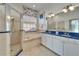 Elegant bathroom with double vanity, soaking tub, and shower at 5614 Seagrass Pl, Apollo Beach, FL 33572
