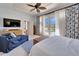 Main bedroom with pool view, comfy seating, and large TV at 5614 Seagrass Pl, Apollo Beach, FL 33572
