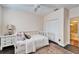 Serene bedroom with white daybed and ensuite bathroom at 5614 Seagrass Pl, Apollo Beach, FL 33572