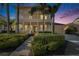 Two-story house with front porch, lit up at night at 5614 Seagrass Pl, Apollo Beach, FL 33572