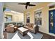 Covered front porch with wicker furniture and rug at 5614 Seagrass Pl, Apollo Beach, FL 33572