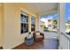 Inviting front porch with wicker chair and tile floor at 5614 Seagrass Pl, Apollo Beach, FL 33572