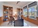 Bright home office with built-in shelving and large windows at 5614 Seagrass Pl, Apollo Beach, FL 33572