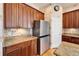 Modern kitchen with granite countertops and stainless steel appliances at 5614 Seagrass Pl, Apollo Beach, FL 33572