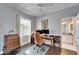 Home office with built-in shelving and hardwood floors at 5614 Seagrass Pl, Apollo Beach, FL 33572