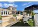 Steps lead down to a patio with firepit and seating at 5614 Seagrass Pl, Apollo Beach, FL 33572