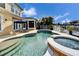 Freeform pool with spa and patio overlooking canal at 5614 Seagrass Pl, Apollo Beach, FL 33572