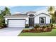 Single-story home with white exterior, gray accents, and landscaping at 5644 Silver Moonlight Dr, Palmetto, FL 34221