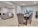 Open concept dining room with gray chairs and a view into the living room at 7815 N 52Nd St, Tampa, FL 33617