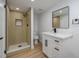 Modern bathroom with walk-in shower and white vanity at 8462 8Th N Way, St Petersburg, FL 33702