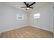 Bright bedroom featuring ceiling fan and light wood flooring at 8462 8Th N Way, St Petersburg, FL 33702